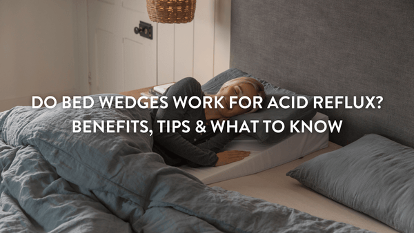 Person sleeping on their side on a Putnams memory foam wedge pillow for acid reflux in a large double bed